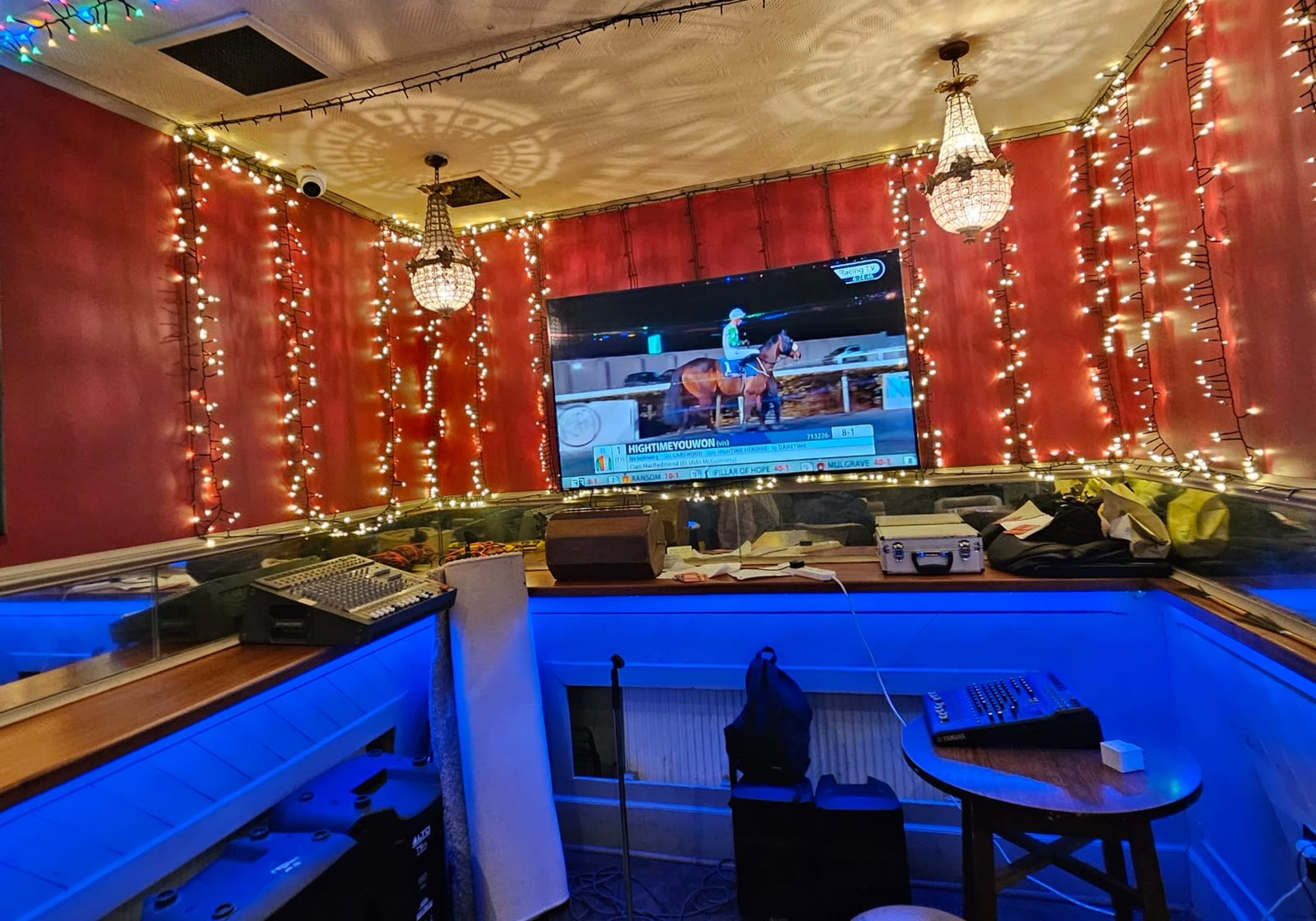 The big screen over the lounge, lit with blue and red lights