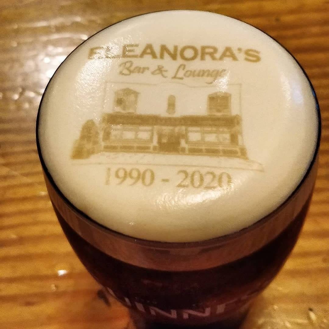 A pint of stout with Eleanora's, a drawing of the pub and 1990 to 2020 printed on its head