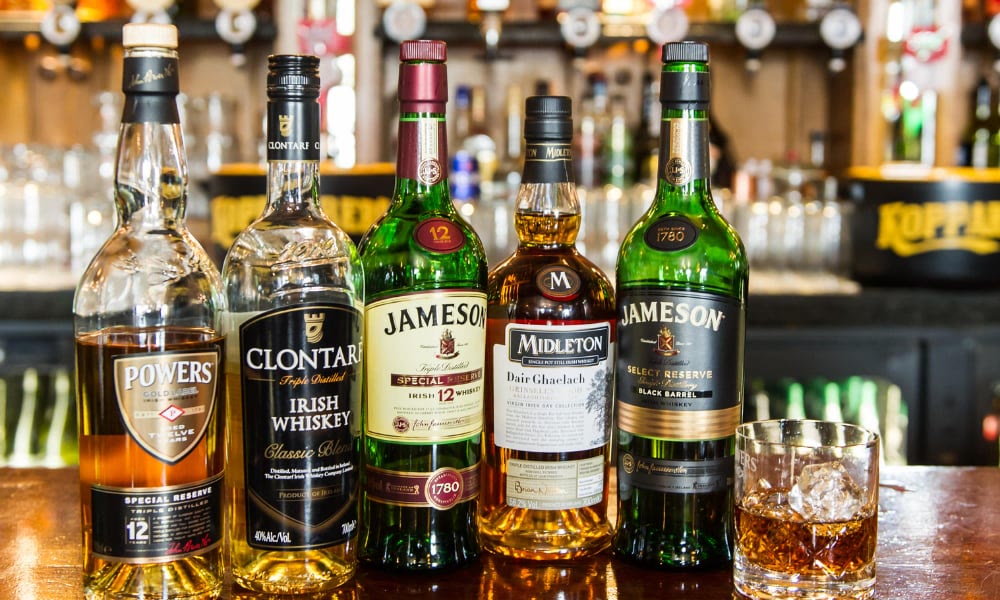 Irish whiskey bottles lined up on the bar